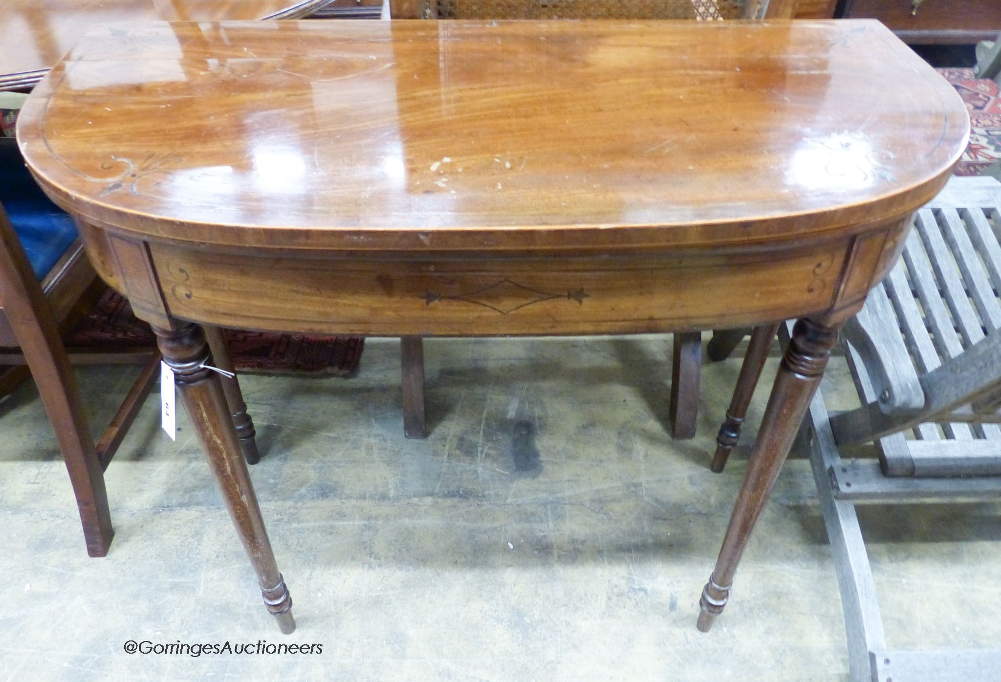 A Regency inlaid mahogany D shaped folding card table, width 92cm, depth 45cm, height 76cm